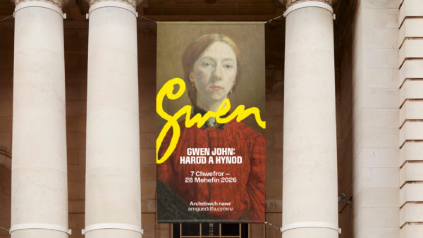 Large banner of Gwen John self-portrait hung between museum entrance columns